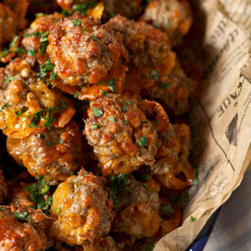 Close up of cream cheese sausage balls garnished with chopped parsley