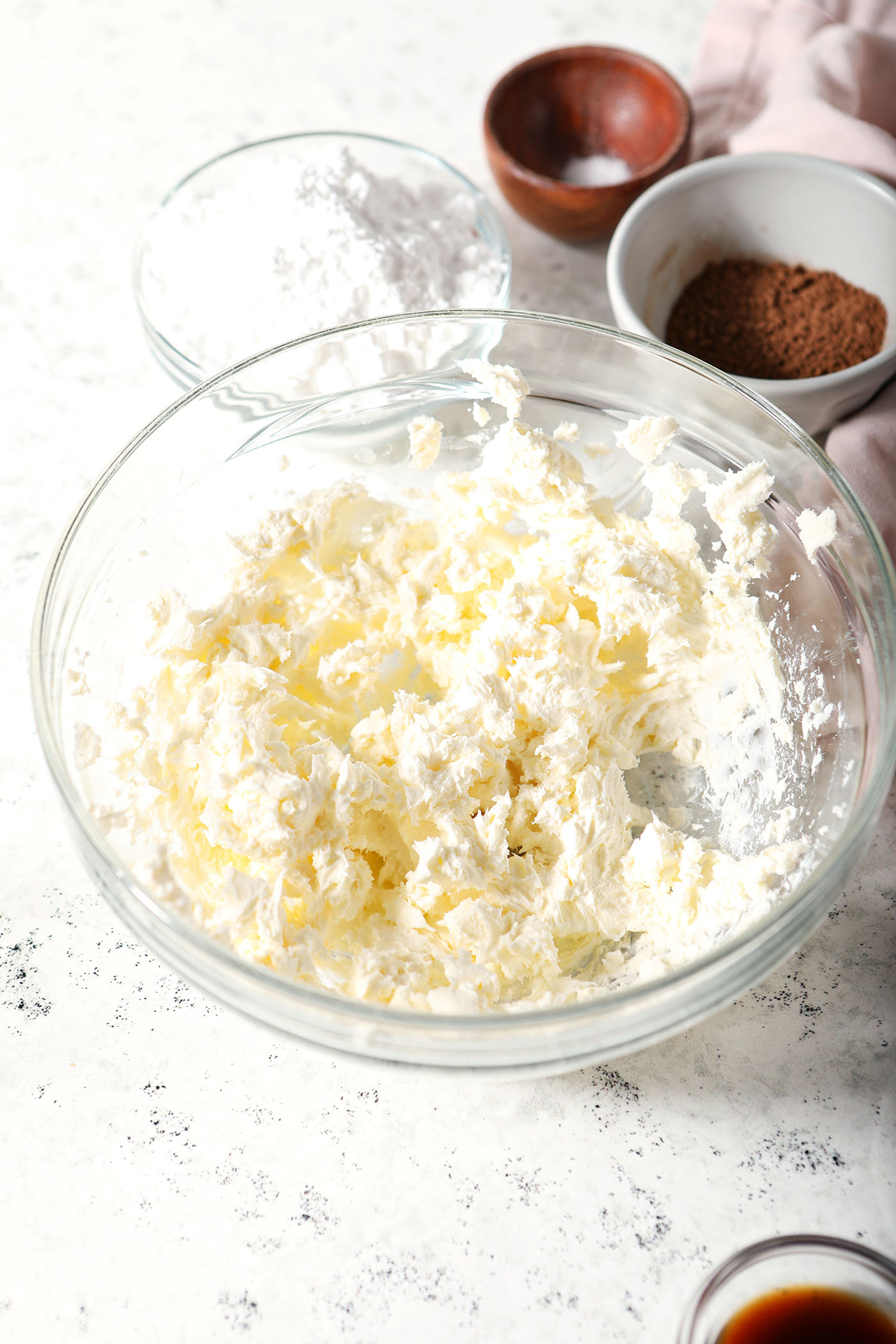 Whipped cream cheese in a bowl on a stoneware surface