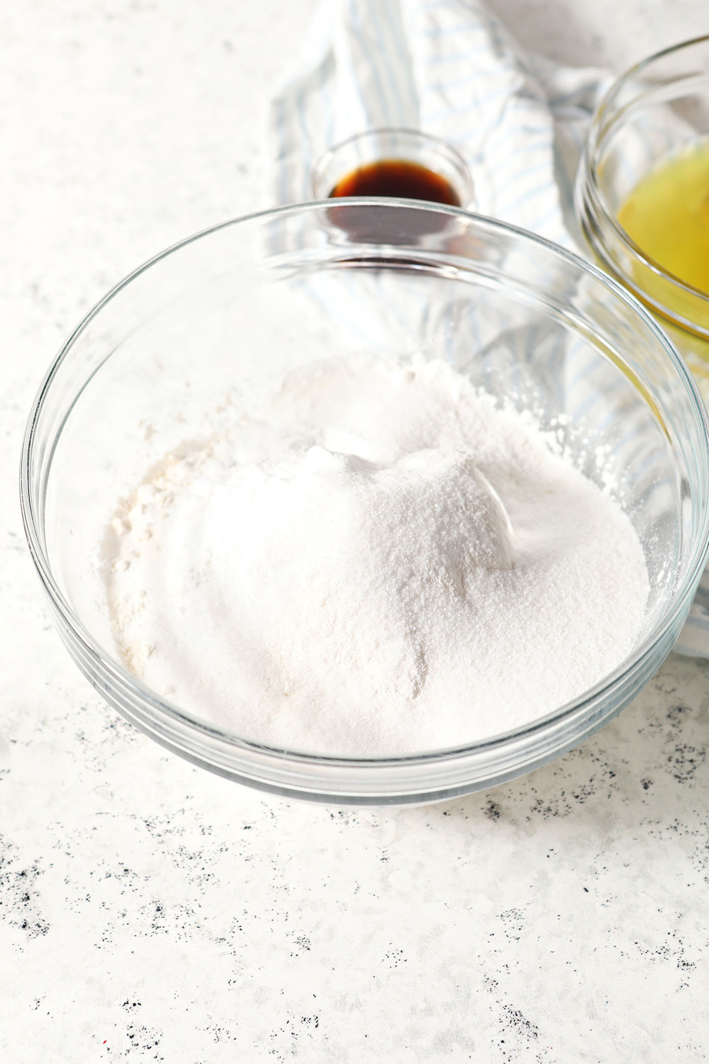 Dry ingredients in a bowl before mixing on a stoneware surface