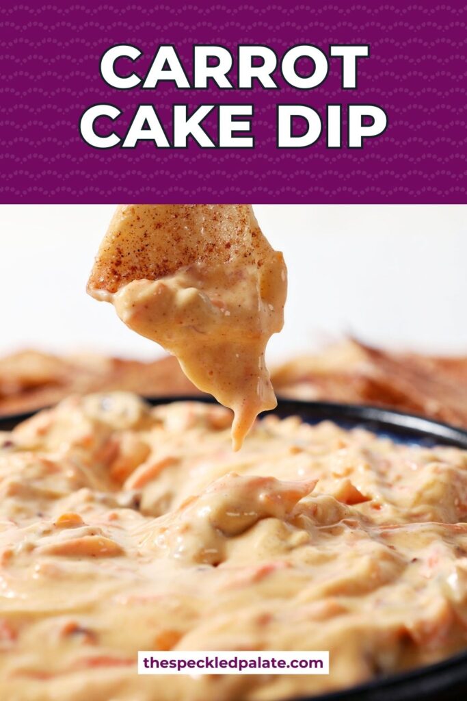 Close up of a hand dipping a chip into carrot cake dip with the text carrot cake dip
