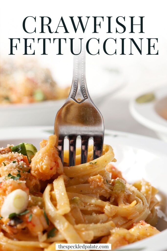 A fork swirls into a bowl of crawfish pasta with the text crawfish fettuccine