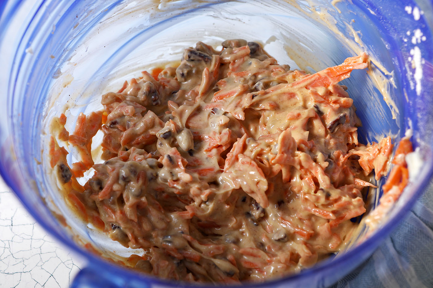 Carrot cake dip in a blue bowl, after blending
