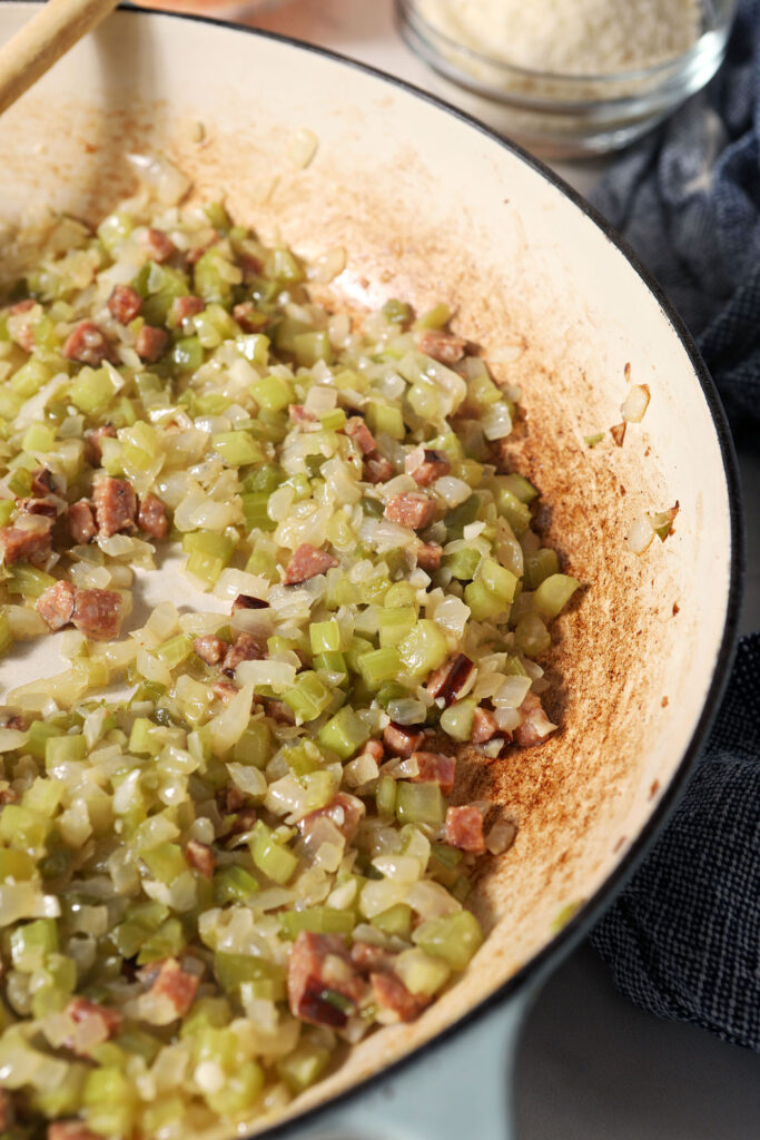 The cajun trinity and garlic in a pan after cooking down with diced andouille sausage