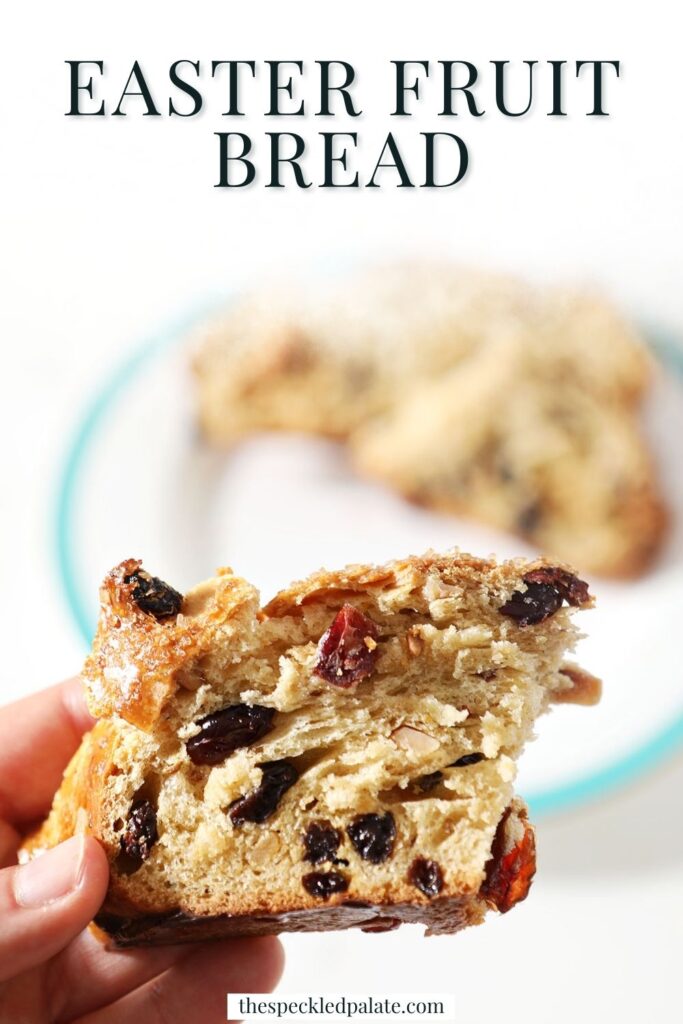 a hand holds a slice of fruit-studded bread with the text easter fruit bread
