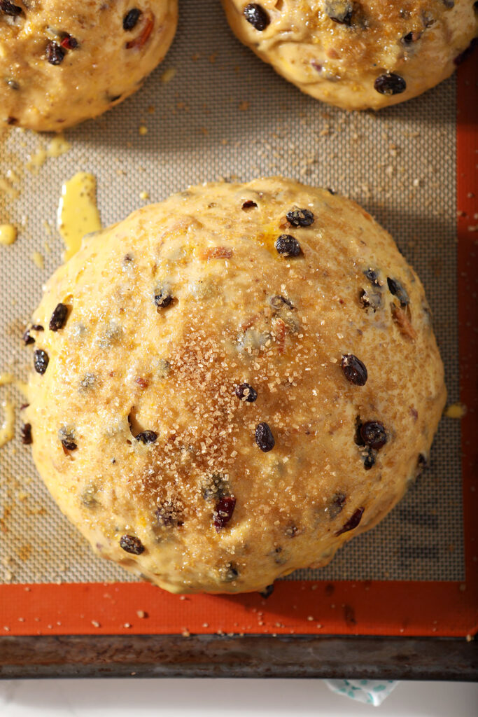 Easter bread, brushed with egg wash and sprinkled with sugar, before baking