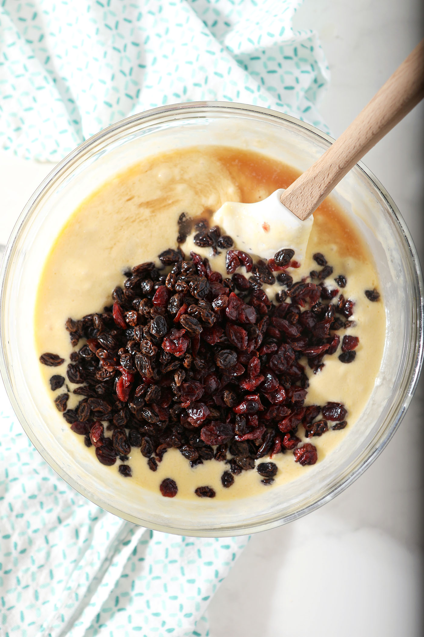 Dried fruit on top of liquid ingredients in a bowl, before mixing
