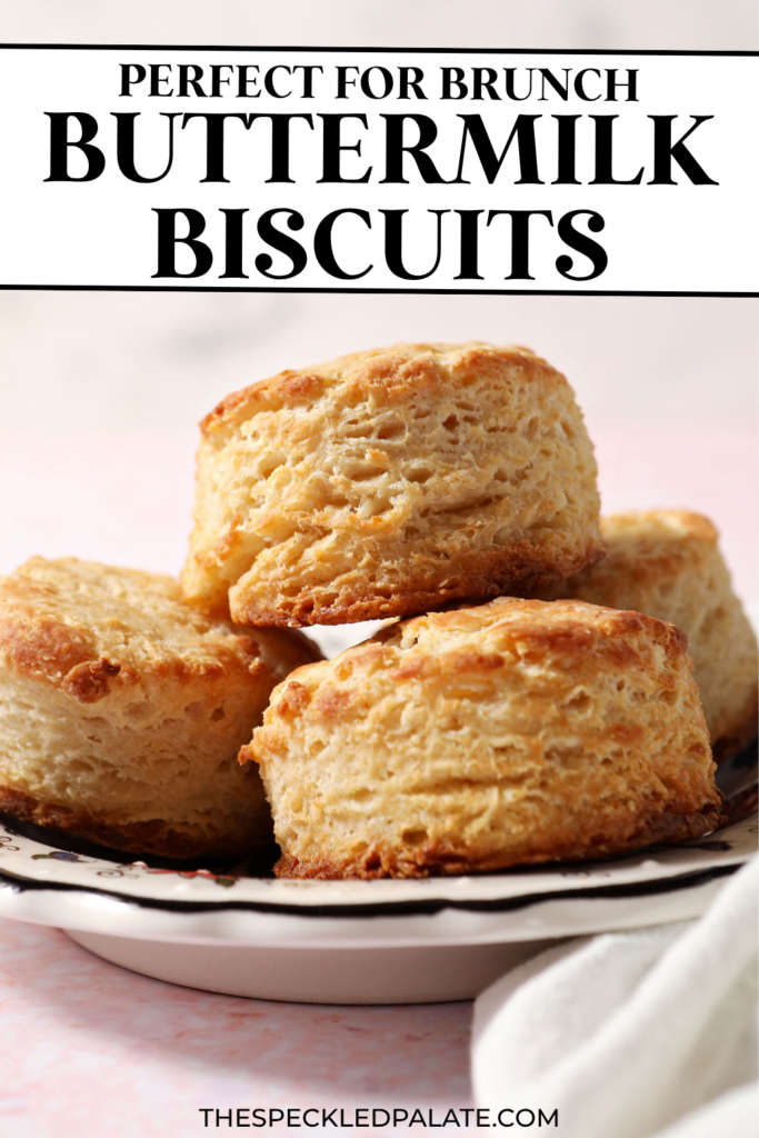 A plate of buttermilk biscuits stacked on a plate on a pink surface with the text perfect for brunch buttermilk biscuits
