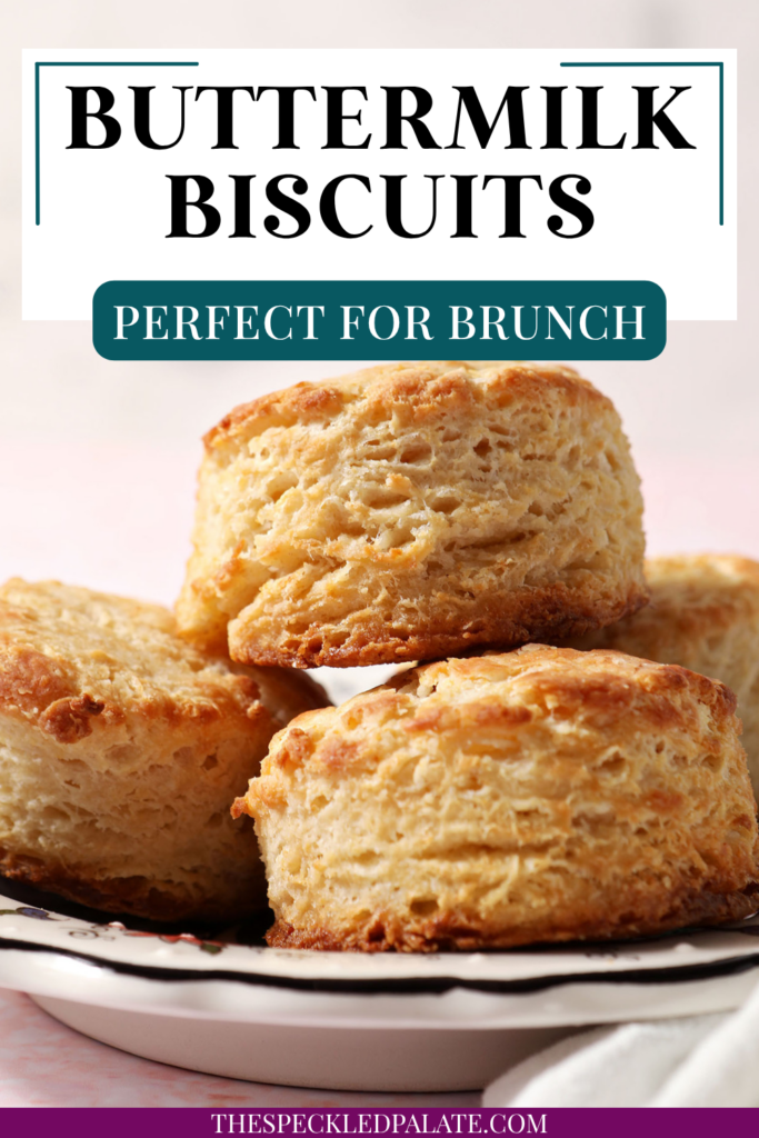 A plate of buttermilk biscuits stacked on a plate on a pink surface with the text buttermilk biscuits perfect for brunch