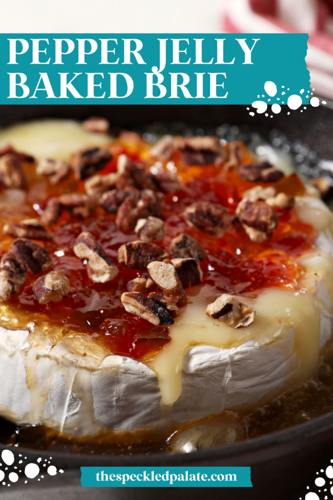 Close up of melty Baked Brie with Pepper Jelly and Toasted Pecans in a cast iron skillet with the text pepper jelly baked brie