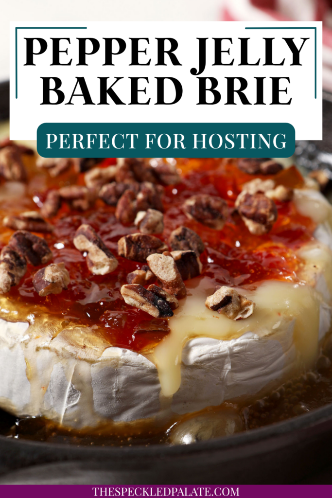 Close up of melty Baked Brie with Pepper Jelly and Toasted Pecans in a cast iron skillet with the text pepper jelly baked brie perfect for hosting