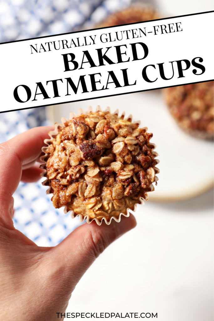 A hand holds an oatmeal muffin cup in hand above a plate with two more and a blue patterned linen