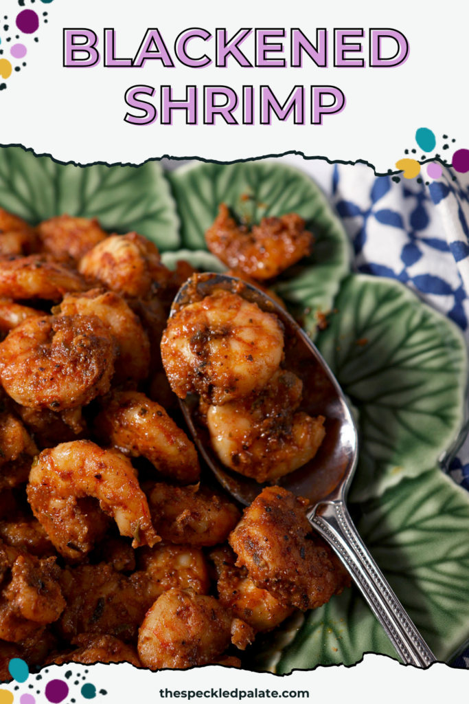 Blackened shrimp piled high on a green plate with a spoon in it. There is text at the top that reads "Blackened Shrimp"