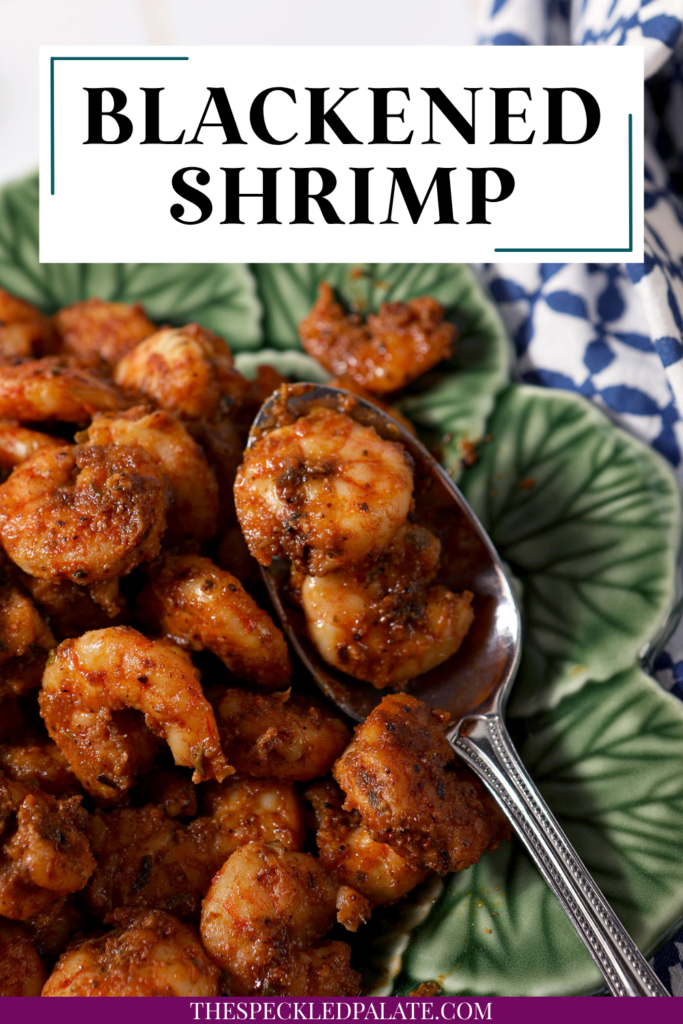 Blackened shrimp piled high on a green plate with a spoon in it. There is text at the top that reads "Blackened Shrimp"