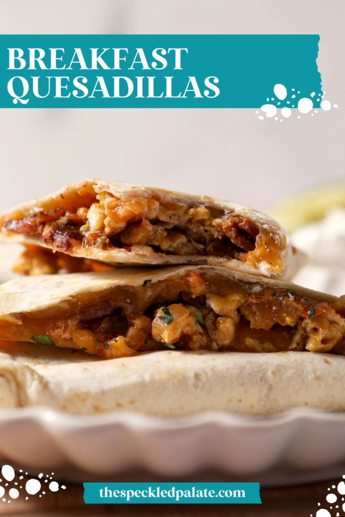 Breakfast quesadillas stacked on a plate on top of a wooden cutting board next to bowls of salsa and sour cream and an avocado. With the Text "Breakfast Quesadillas" written across the top.