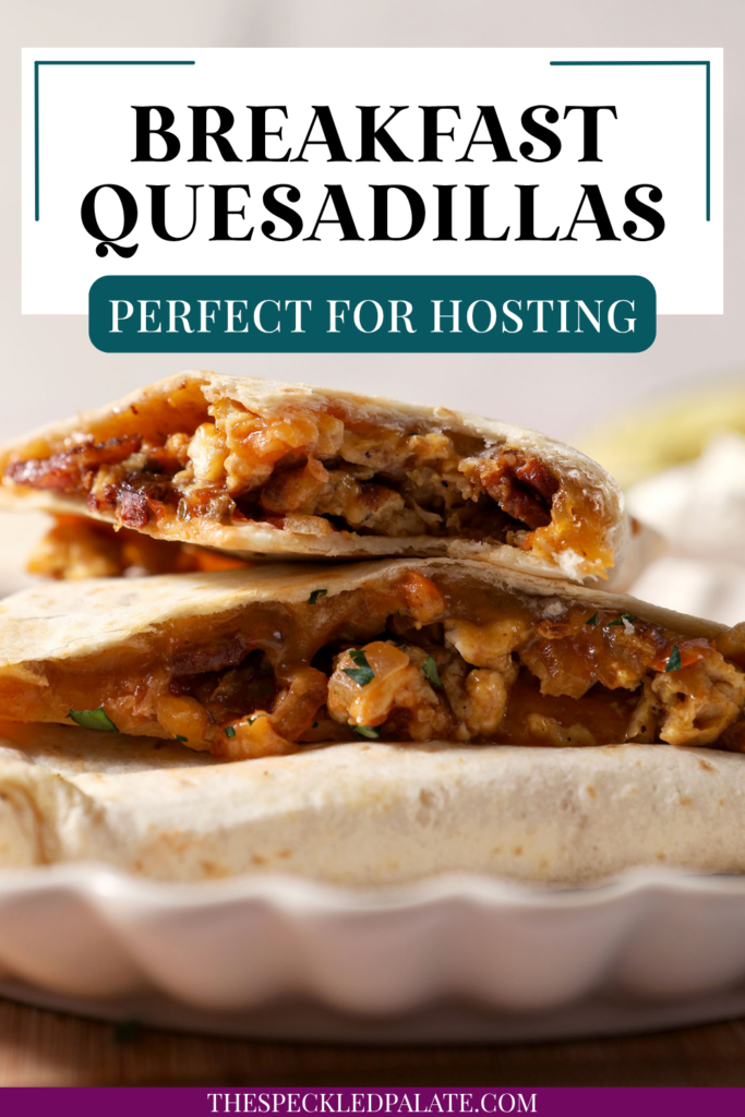 Breakfast quesadillas stacked on a plate on top of a wooden cutting board next to bowls of salsa and sour cream and an avocado. With the Text "Breakfast Quesadillas. Perfect for Hosting." written across the top.