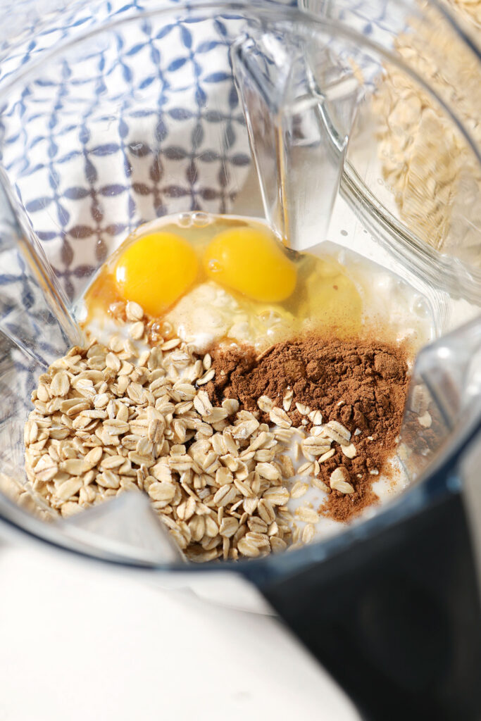 Oats and other ingredients in the base of a blender, before blending