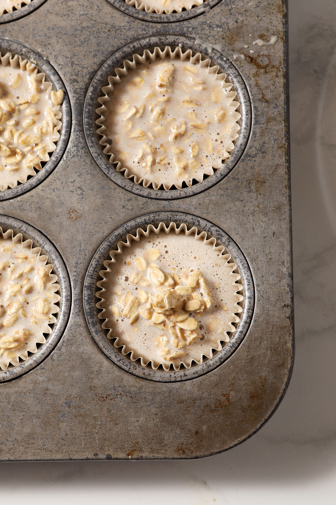 Oatmeal cups in muffin tins before baking