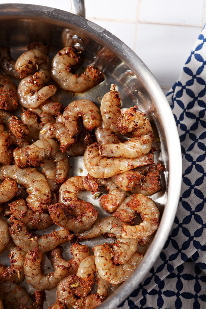 Shrimp begins cooking in a skillet