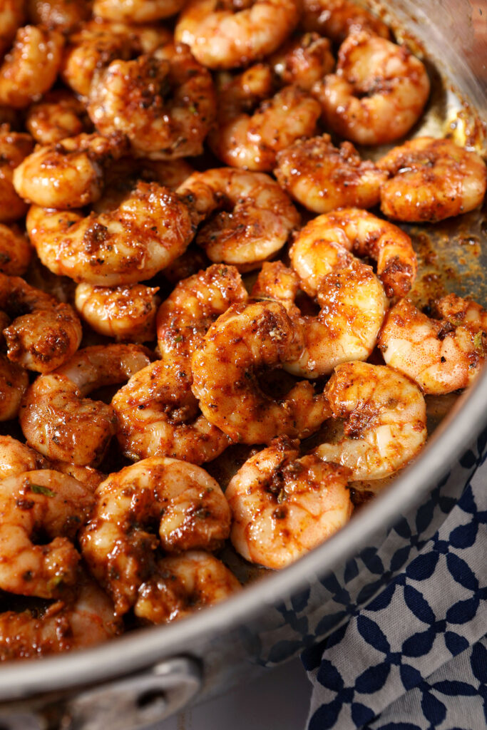 Closeup of blackened shrimp in a skillet