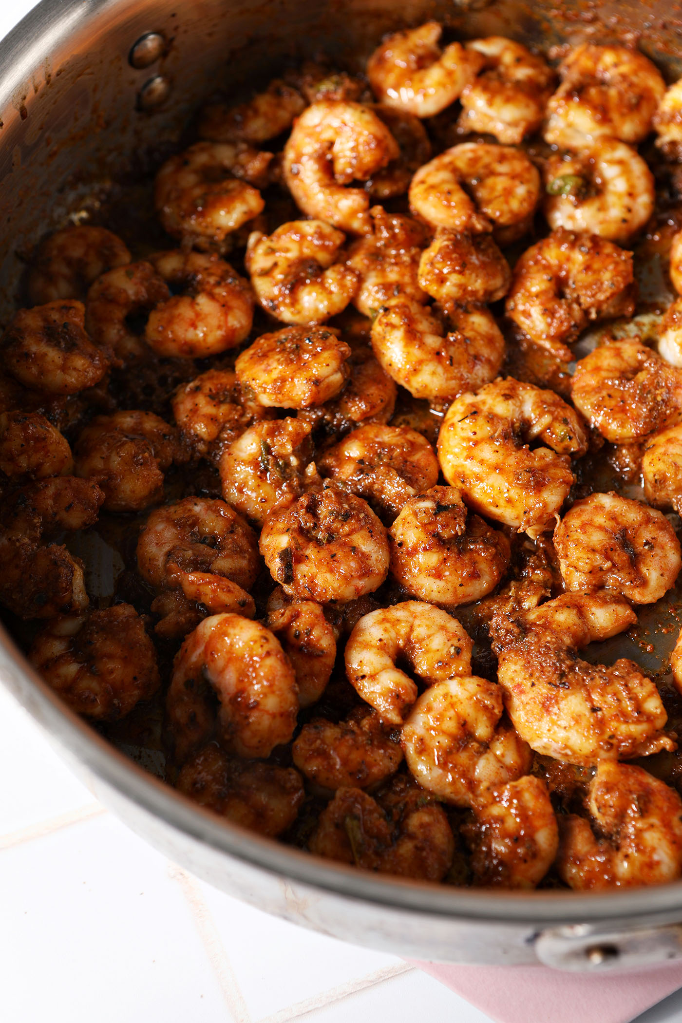 Cooked blackened shrimp in a skillet