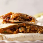 Stacked breakfast quesadillas on top of themselves on a plate