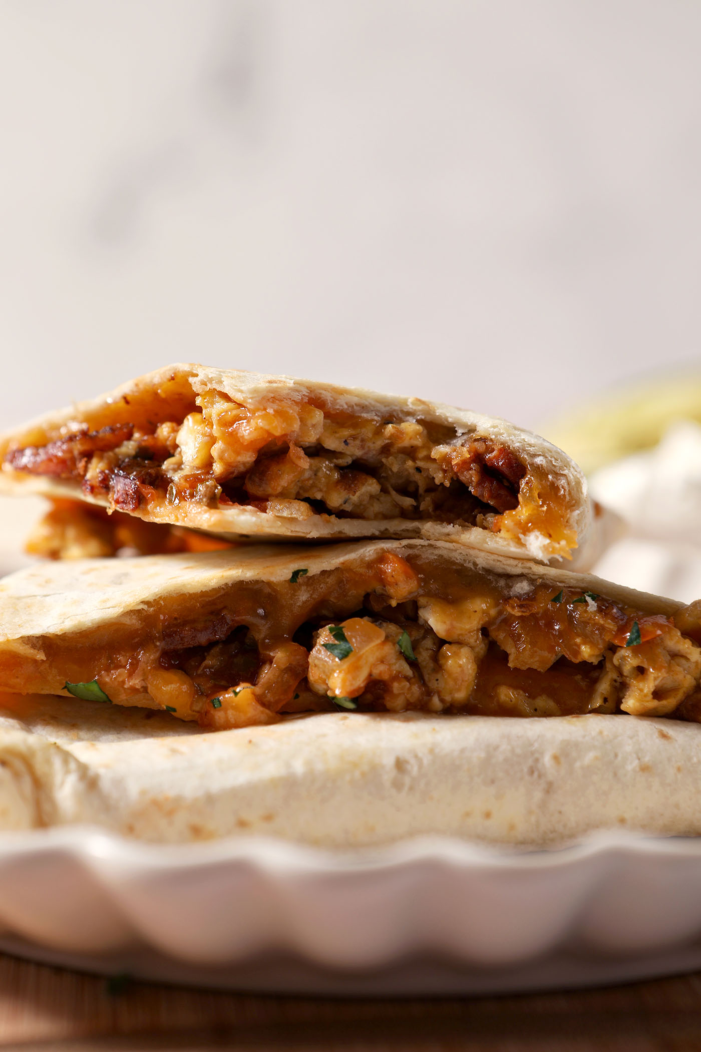 Stacked breakfast quesadillas on top of themselves on a plate