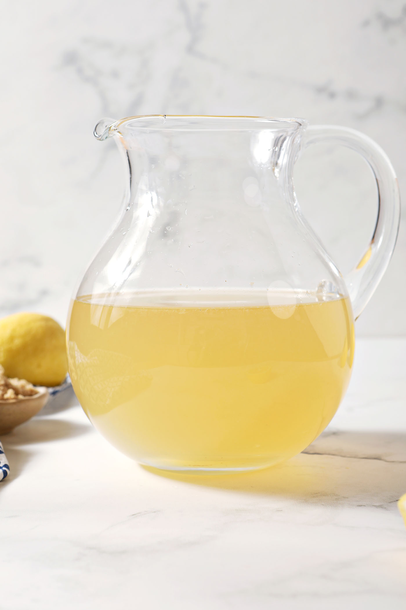 Brown sugar syrup in a pitcher on a marble surface