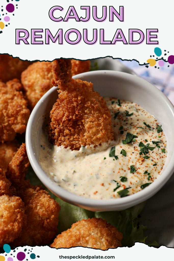 a plate of fried shrimp surrounding the cajun remoulade sauce cup with a shrimp dipped into the cajun remoulade sauce. With text at the top saying "Cajun Remoulade"