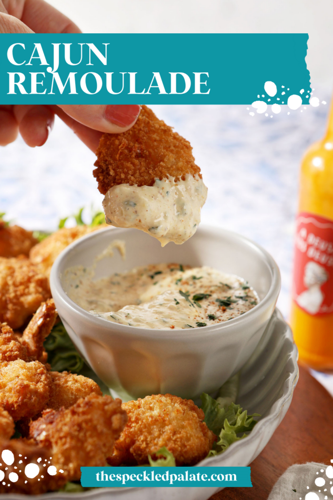 a plate of fried shrimp surrounding the cajun remoulade sauce cup with a shrimp dipped into the cajun remoulade sauce. With text at the top saying "Cajun Remoulade"