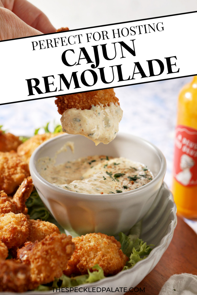a plate of fried shrimp surrounding the cajun remoulade sauce cup with a shrimp dipped into the cajun remoulade sauce. With text at the top saying "Cajun Remoulade"