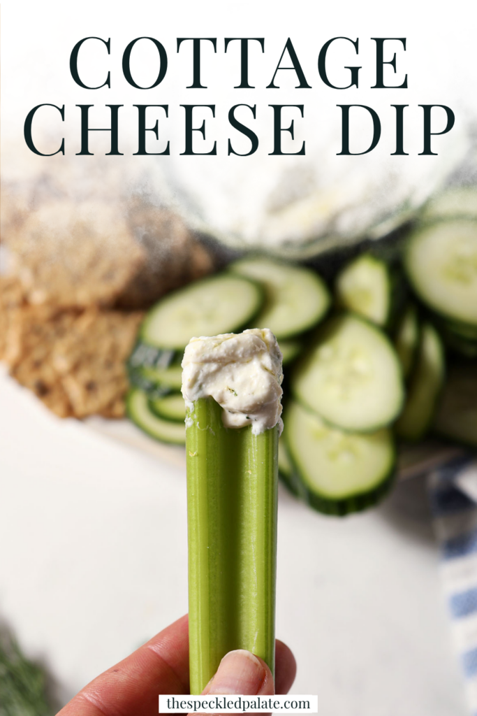 a celery stick holds a bite of cottage cheese dip above a platter with the text cottage cheese dip