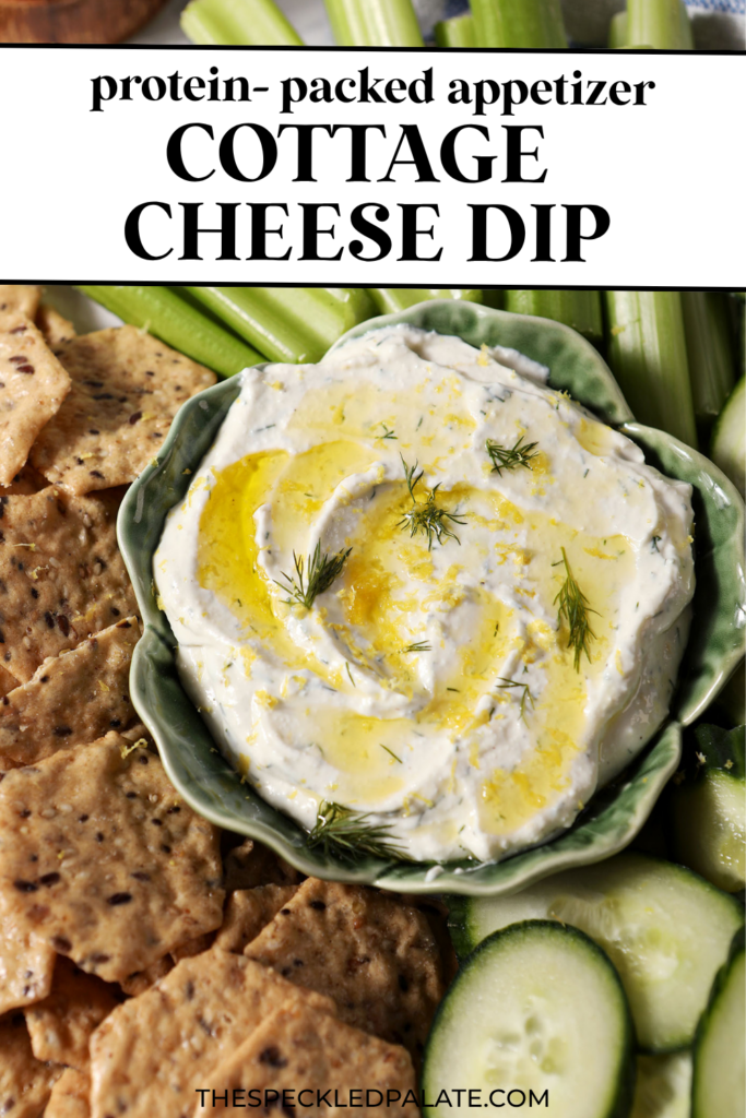Overhead of Cottage Cheese Dip, garnished with dill, olive oil and lemon zest, on a platter with crackers, cucumber rounds and celery sticks with the text cottage cheese dip