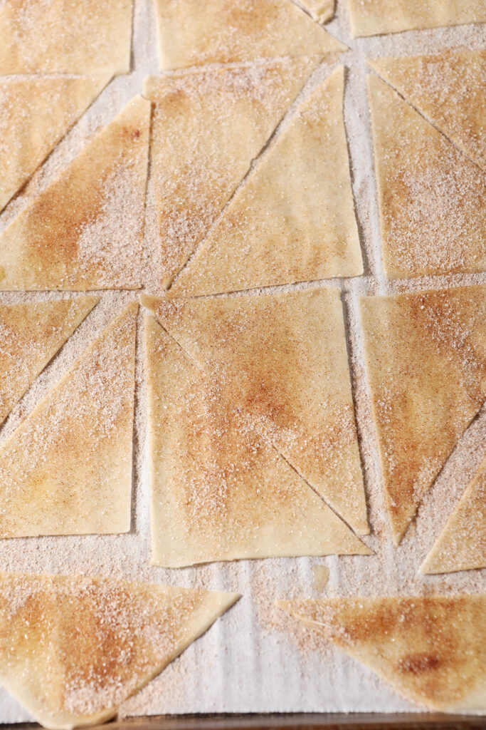Wontons sprinkled with cinnamon sugar on a sheet pan