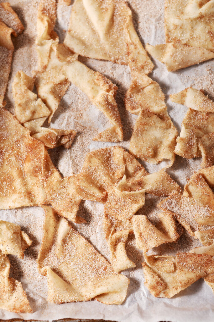 Cinnamon sugar wontons on a sheet pan before baking