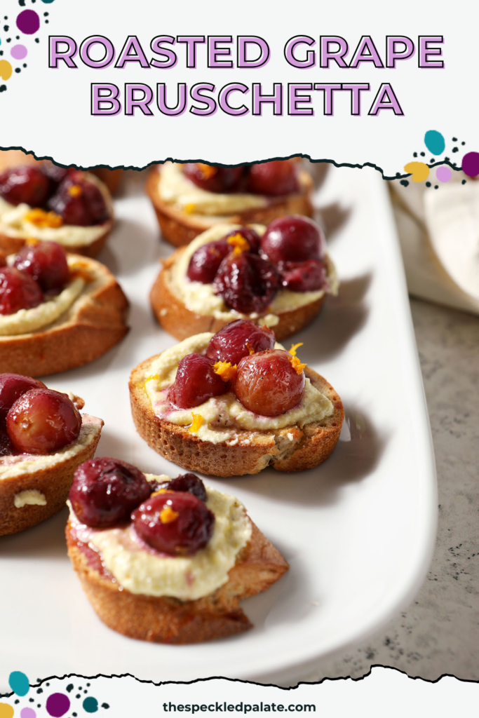 Side angle of Roasted Grape Bruschetta with Whipped Feta on a white platter