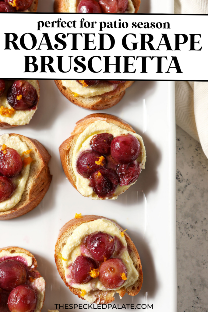Side angle of Roasted Grape Bruschetta with Whipped Feta on a white platter