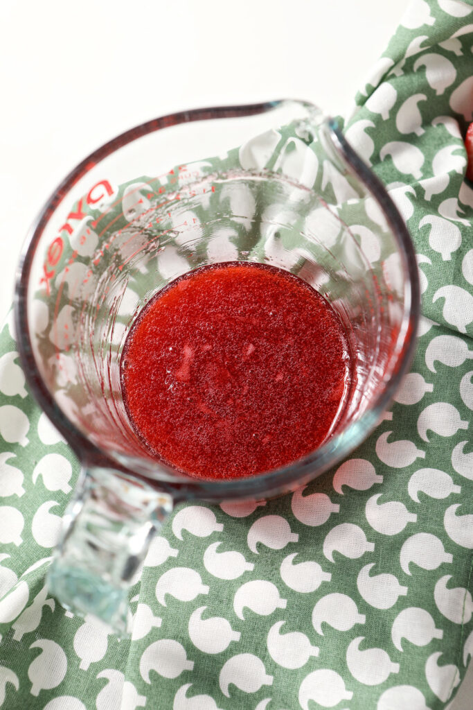 Strawberry syrup in a liquid measuring cup