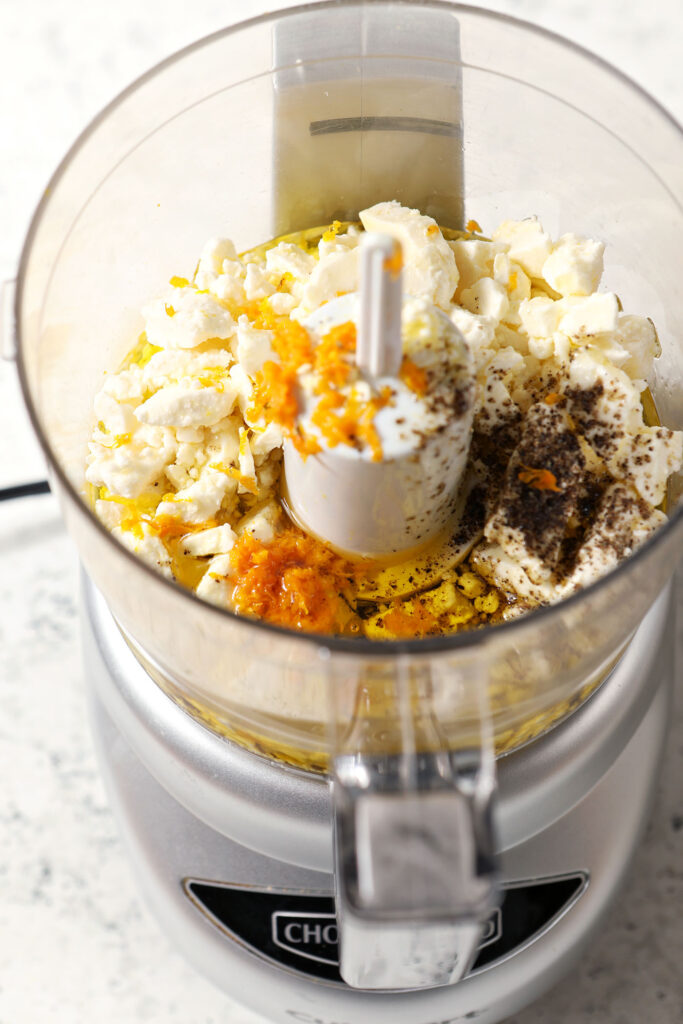 Ingredients to make whipped feta spread in a food processor, before blending