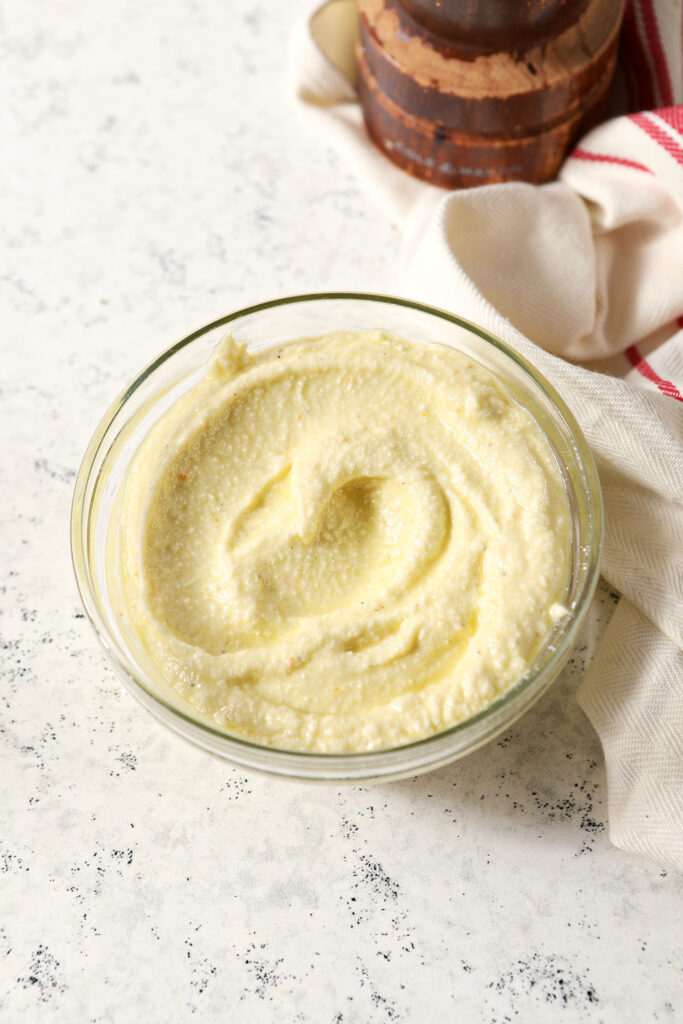 Whipped feta spread on a white stone surface