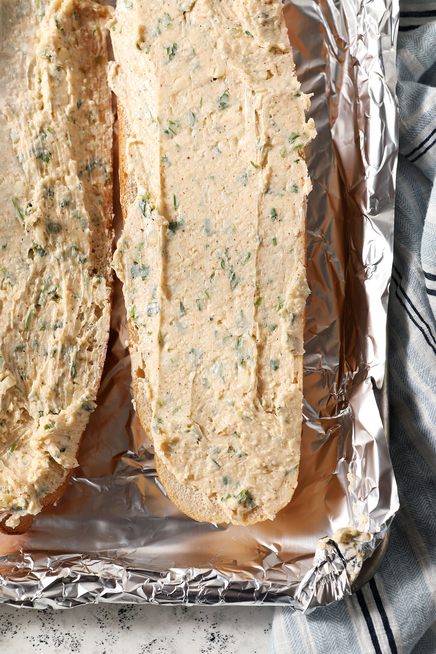 Cajun garlic bread on a sheet pan lined with foil