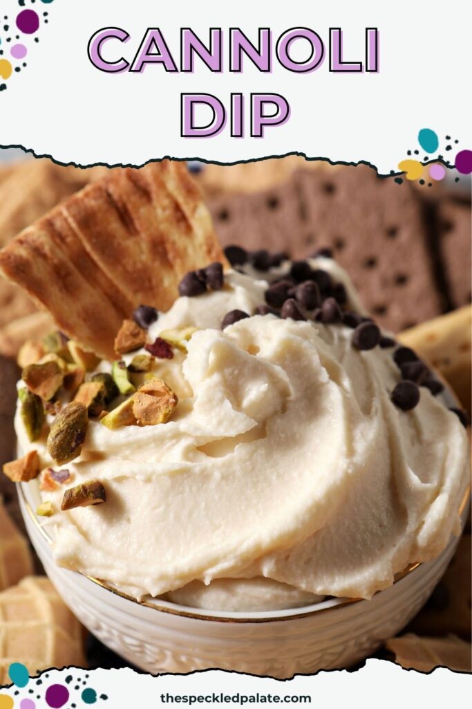 A waffle chip dunked into creamy cannoli dip sprinkled with chocolate chips and pistachios with the text "Cannoli Dip" on the top.