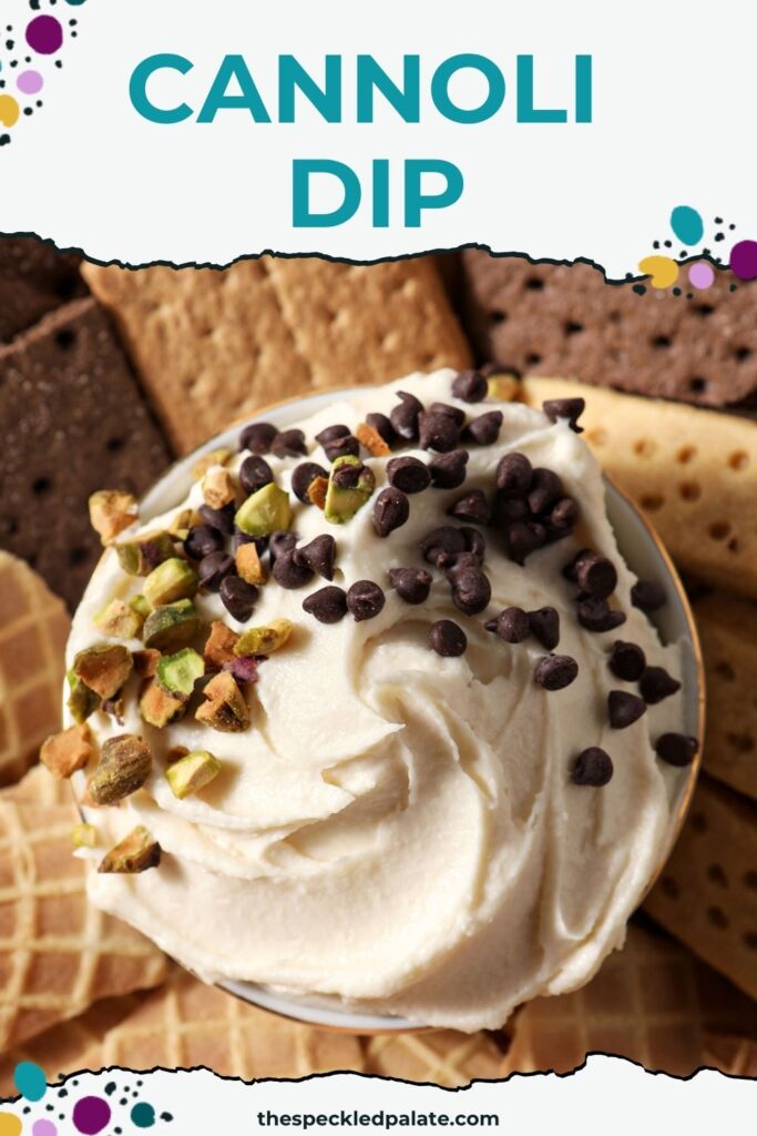 Sweet Cannoli Dip garnished with chopped pistachios and miniature chocolate chips in the middle of various dippers on a platter with the text cannoli dip