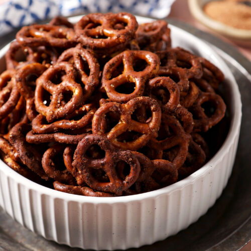 Close-up of Cajun pretzels in a white bowl on a silver tray