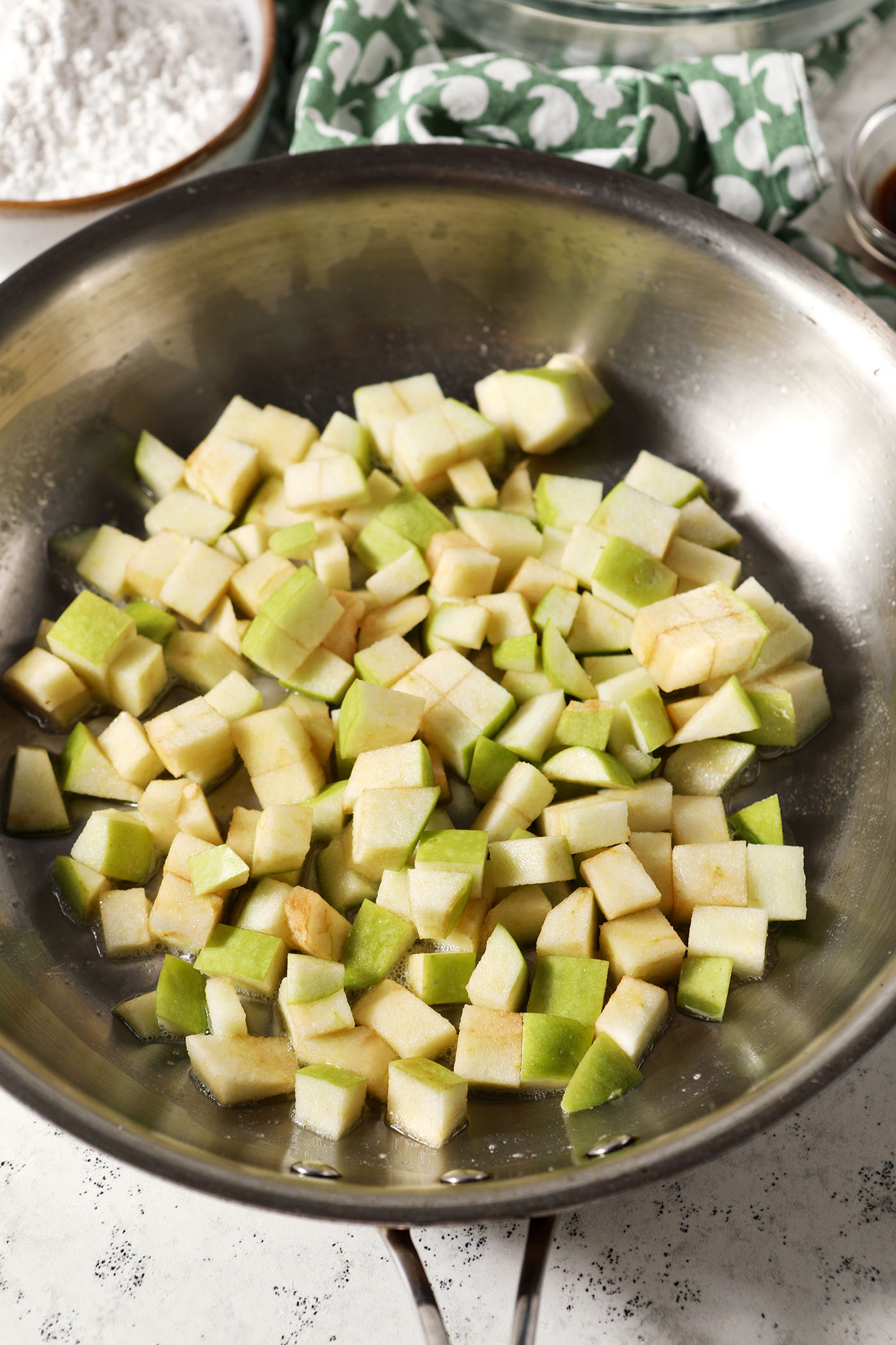 Diced apples in a skillet with butter