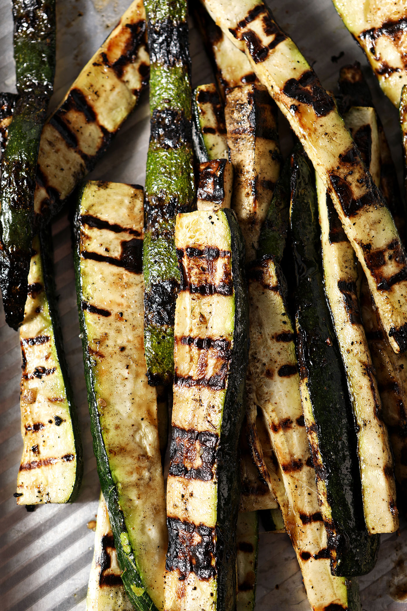 Grilled zucchini on a sheet pan from above.