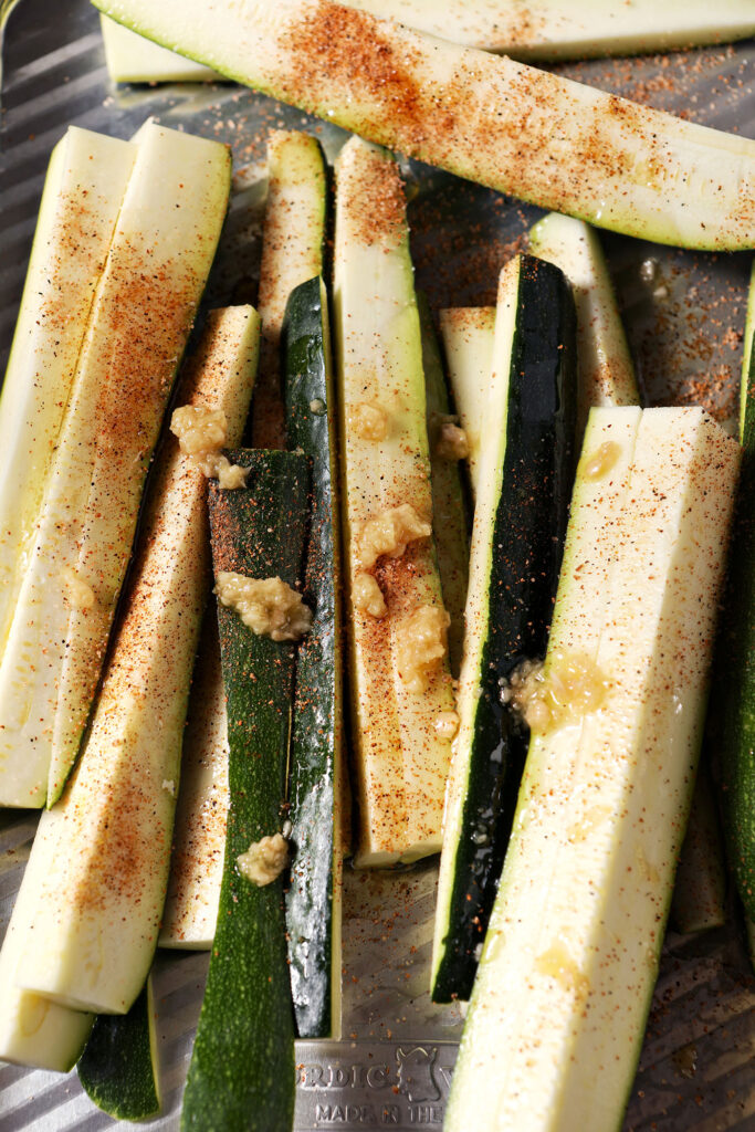 Zucchini wedges seasoned with avocado oil, Cajun seasoning and grated garlic.