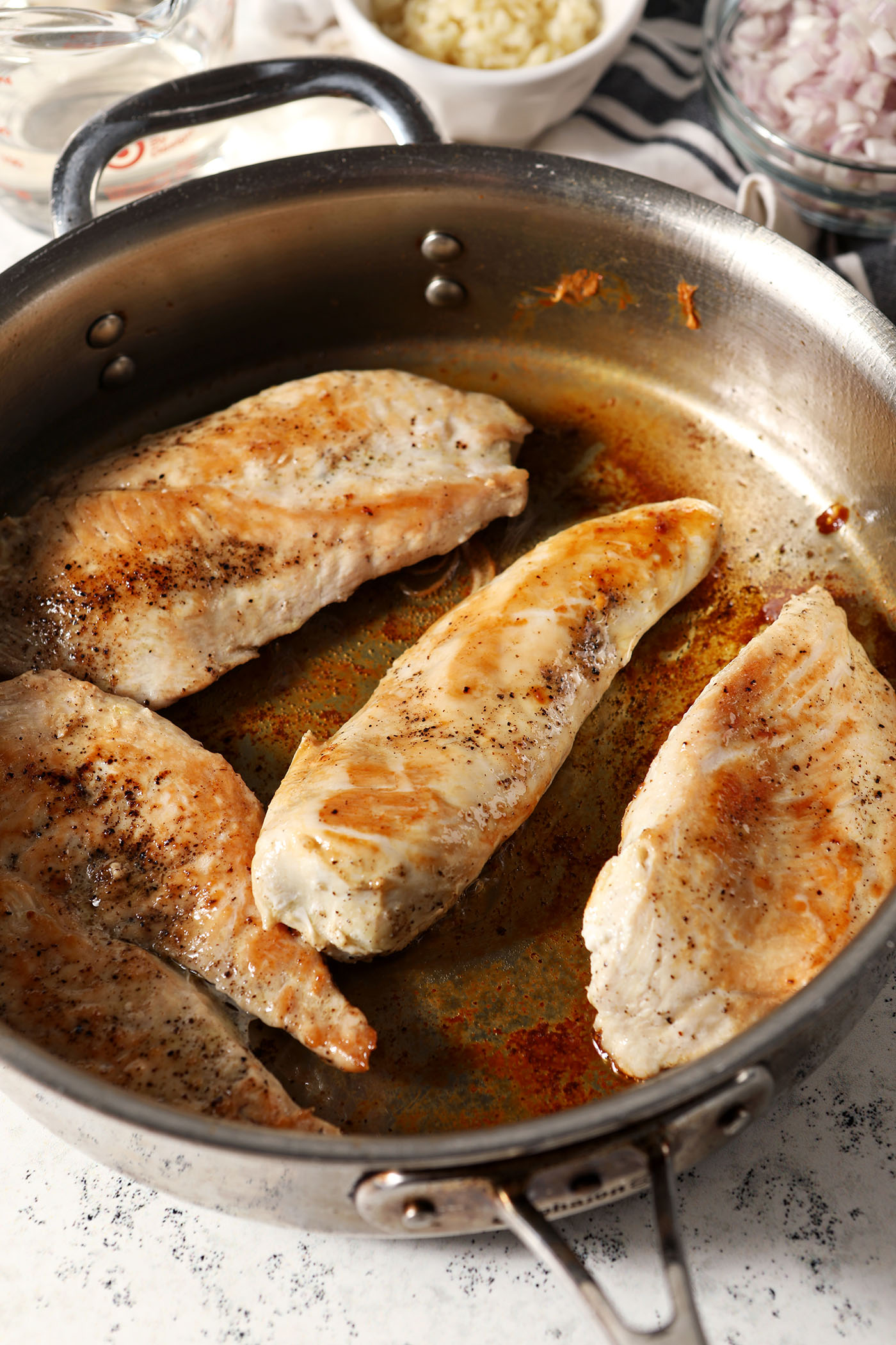 Seared chicken breasts in a skillet