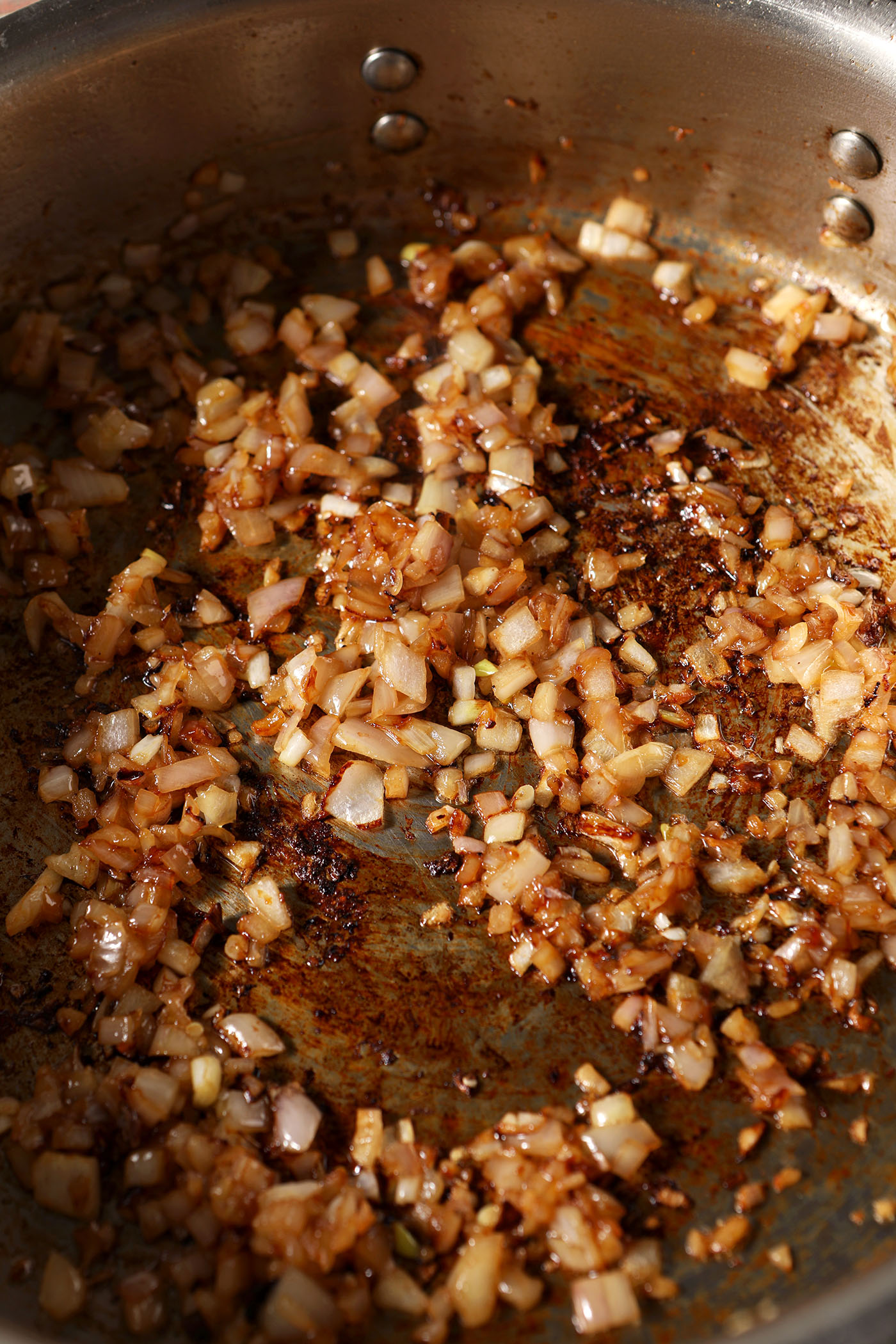 Close-up of cooked-down minced shallots in a skillet