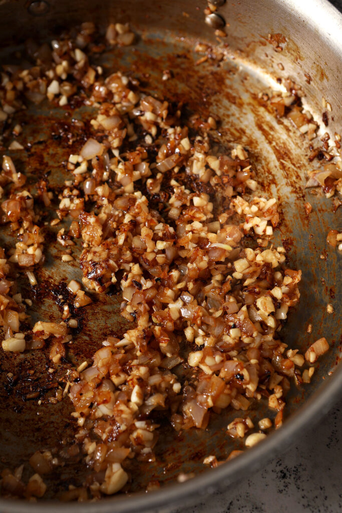 Cooked down garlic and shallots in a skillet