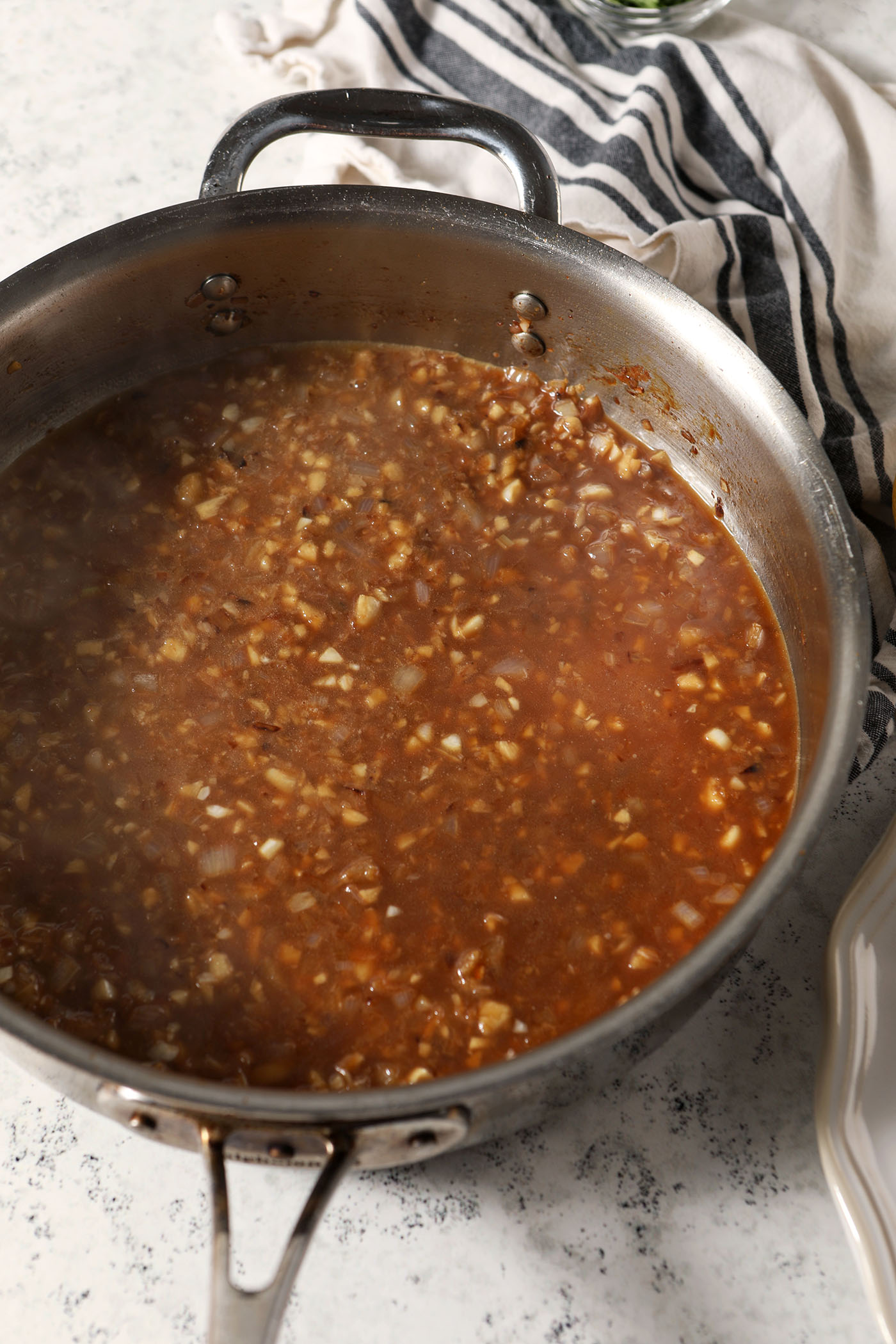 Lemon garlic sauce in a skillet before cooking down